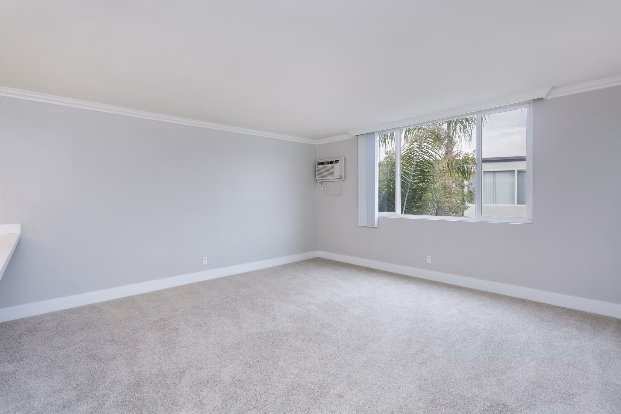 Cozy bedroom with modern decor at 1200 Riverside Apartments with views of the river