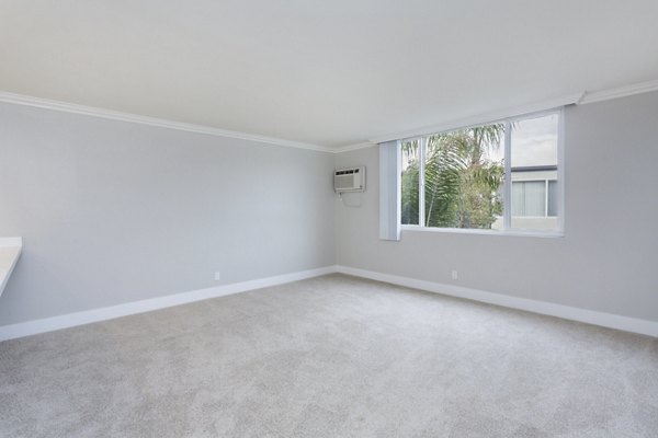 Cozy bedroom with modern decor at 1200 Riverside Apartments with views of the river
