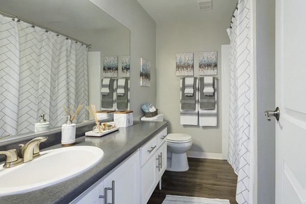 Bathroom at 1200 Riverside Apartments featuring sleek fixtures and modern design