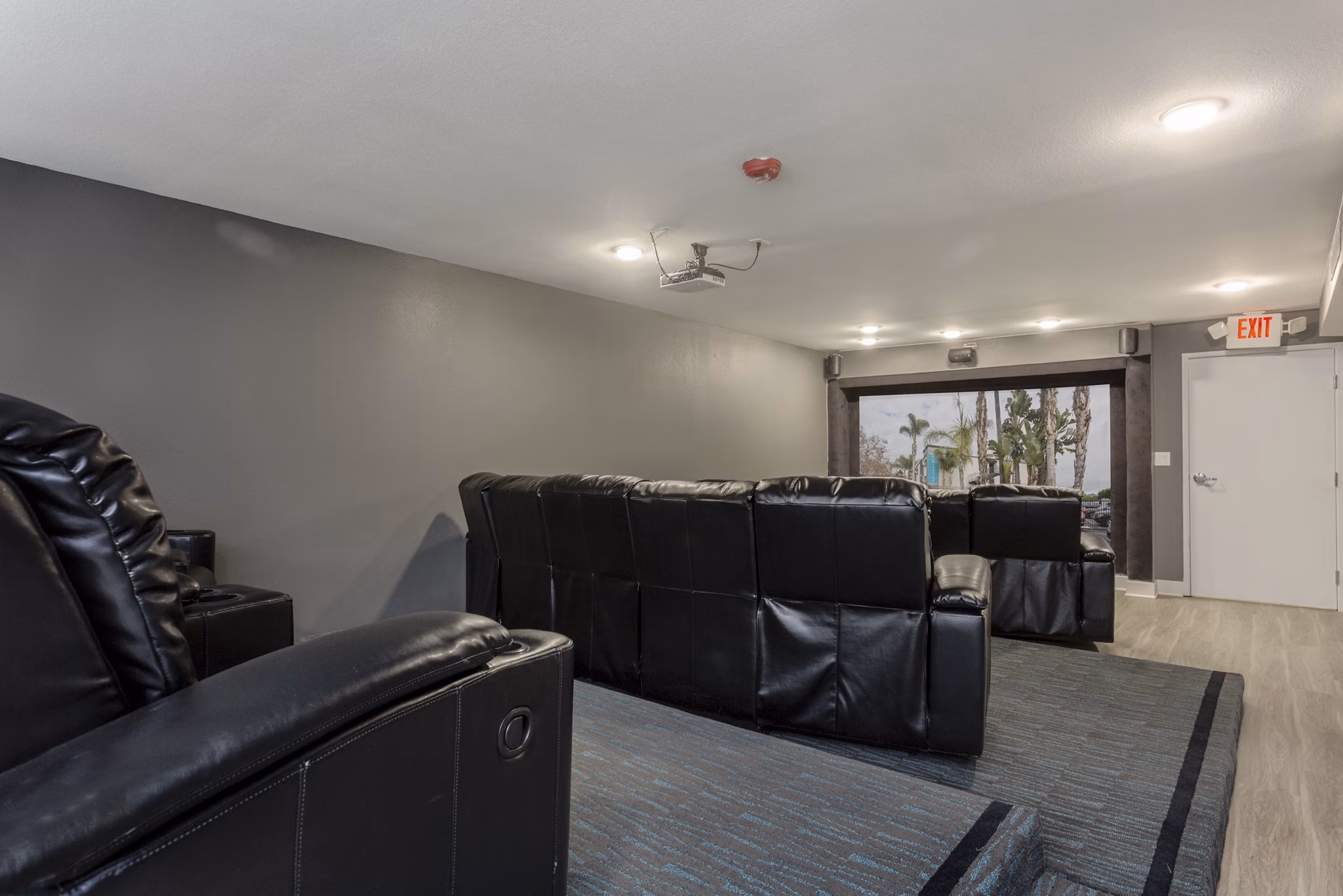 Theater with plush seating and advanced acoustics at 1200 Riverside Apartments offers luxury entertainment experience