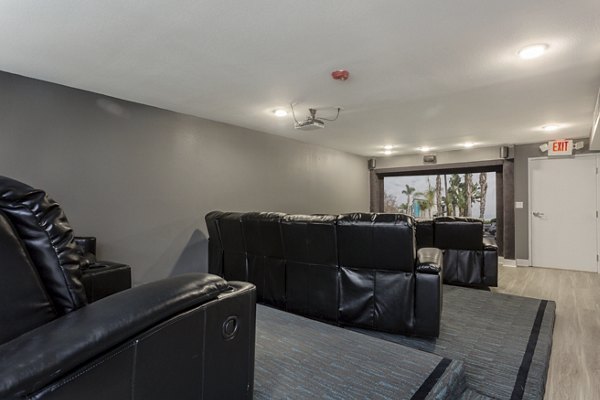 Theater with plush seating and advanced acoustics at 1200 Riverside Apartments offers luxury entertainment experience