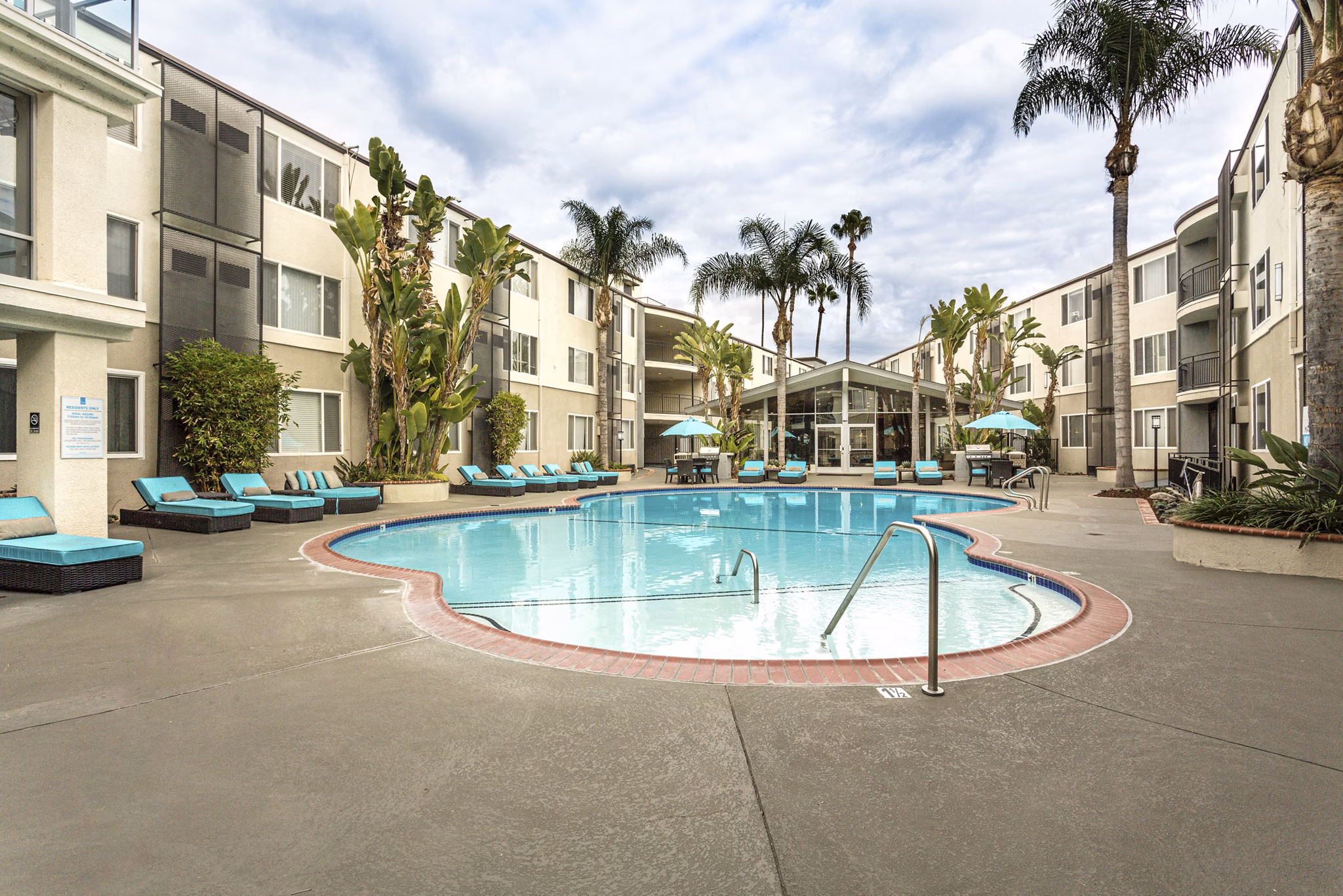 Relaxing outdoor pool at 1200 Riverside Apartments offering luxury amenities in a serene setting