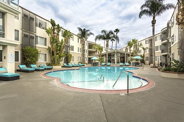 Relaxing outdoor pool at 1200 Riverside Apartments offering luxury amenities in a serene setting