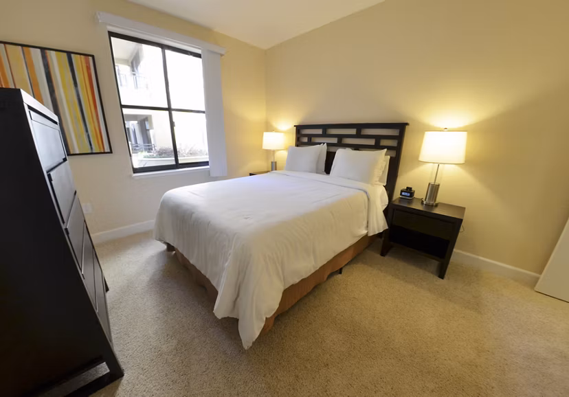 Bedroom featuring luxury furnishings at The Windsor Apartments by Greystar