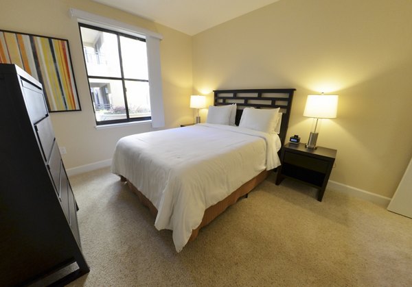 Bedroom featuring luxury furnishings at The Windsor Apartments by Greystar