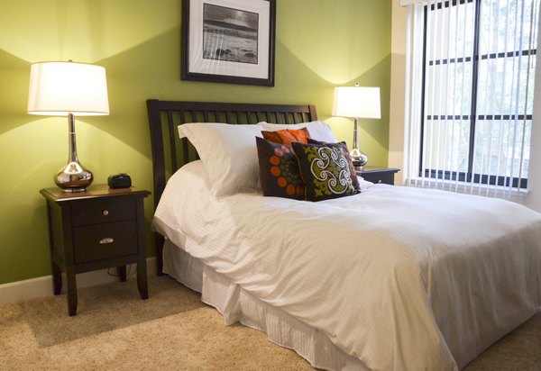 The Windsor Apartments: Modern bedroom with elegant furnishings and large windows for luxury living