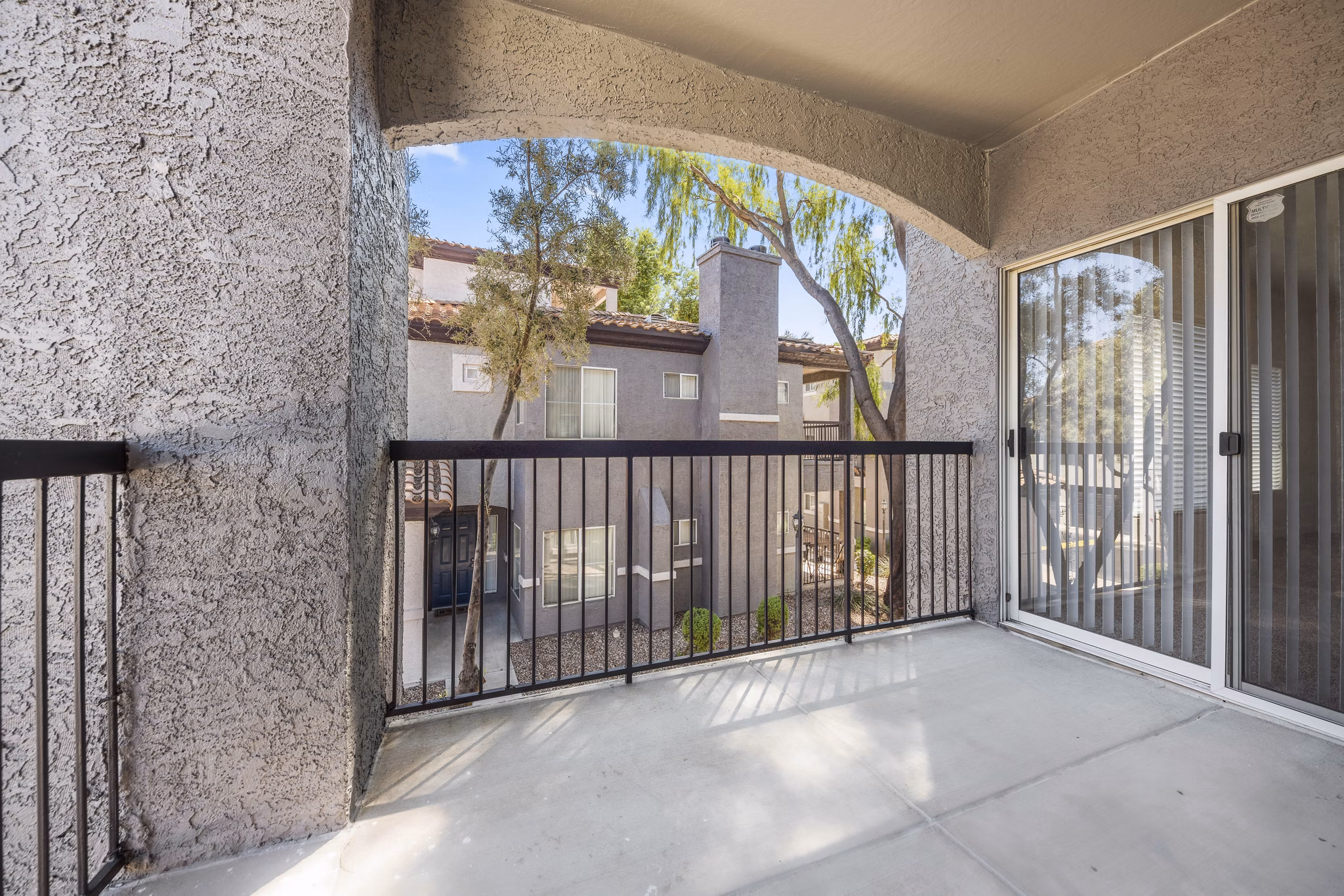 Private patio with outdoor seating at GlenEagles Apartments, ideal for relaxation and enjoying scenic views