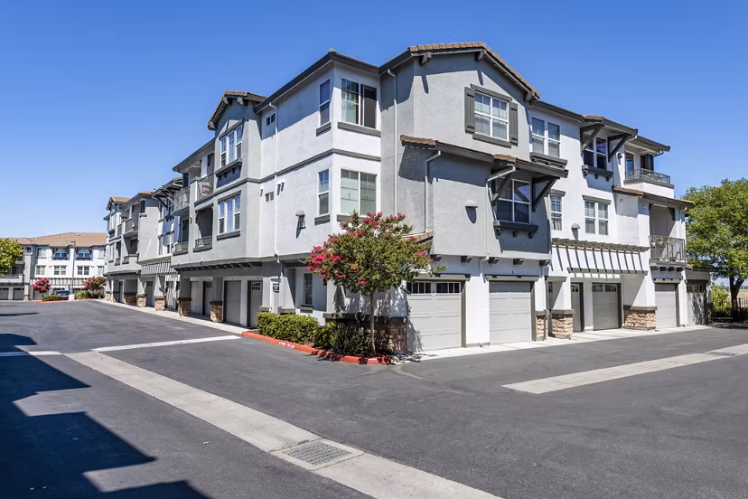Luxury apartment complex with multiple units and garages in a modern residential setting