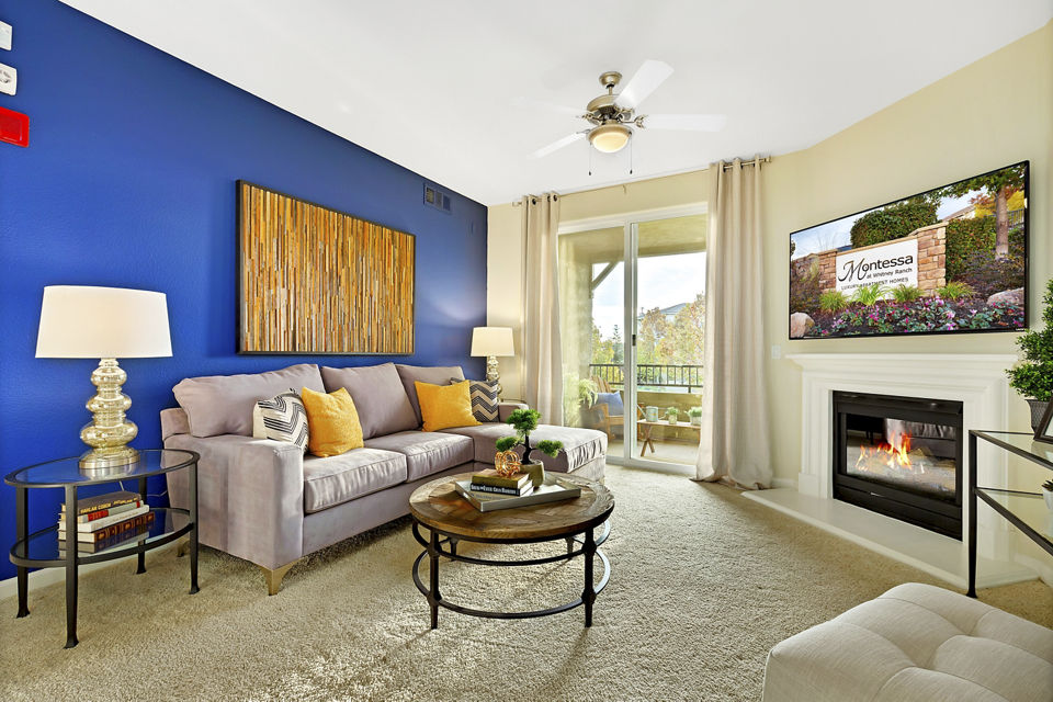Modern living room with cozy seating and abundant natural light at Montessa At Whitney Ranch Apartments