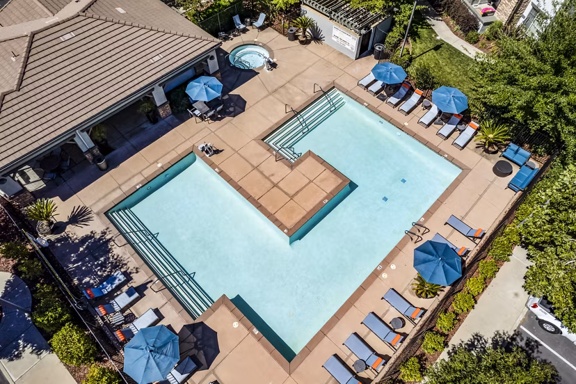 Poolside view at Montessa at Whitney Ranch Apartments, featuring luxury pool and outdoor seating for relaxation
