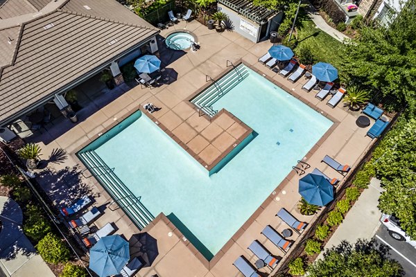 Poolside view at Montessa at Whitney Ranch Apartments, featuring luxury pool and outdoor seating for relaxation
