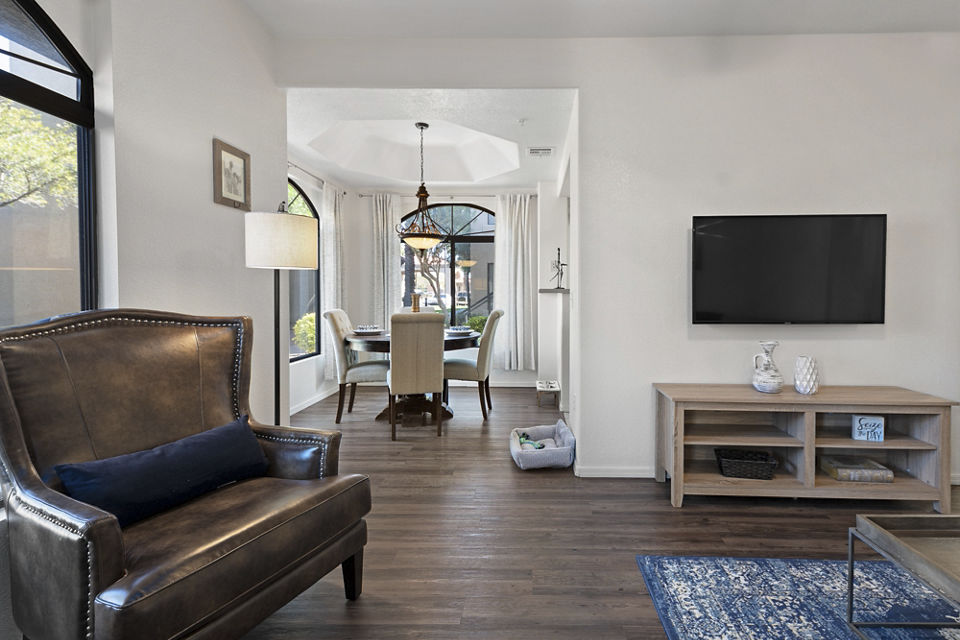Elegant living room with plush seating and natural light at San Cierra Apartments