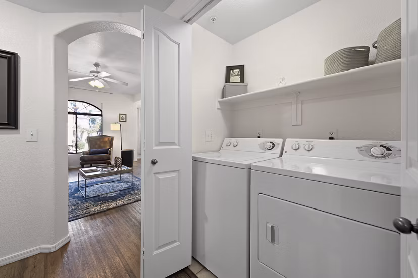Laundry room with modern appliances at San Cierra Apartments, a Greystar luxury community