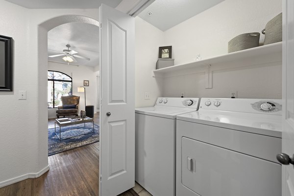 Laundry room with modern appliances at San Cierra Apartments, a Greystar luxury community