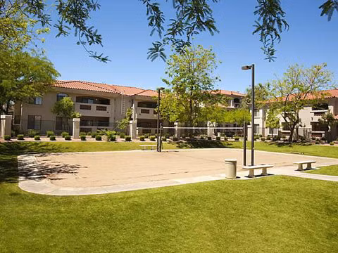 San Cierra Apartments: Sport court surrounded by lush landscaping for recreation and relaxation
