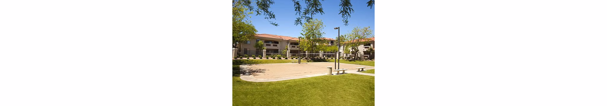 San Cierra Apartments: Sport court surrounded by lush landscaping for recreation and relaxation