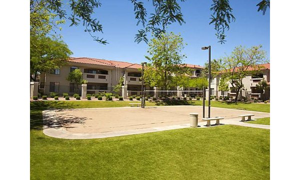 San Cierra Apartments: Sport court surrounded by lush landscaping for recreation and relaxation