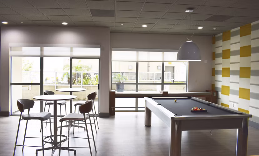 NoHo 14 Apartments: Chic clubhouse with contemporary design and cozy seating, ideal for social gatherings and relaxation