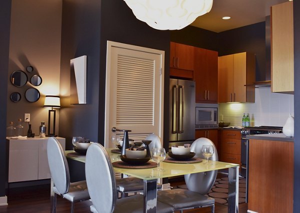 Dining area with modern lighting and sleek furniture in NoHo 14 Apartments
