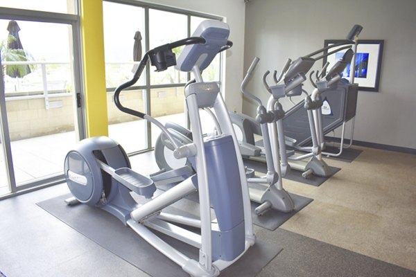 Fully-equipped fitness center with cardio machines at NoHo 14 Apartments An ideal workout space in modern luxury living