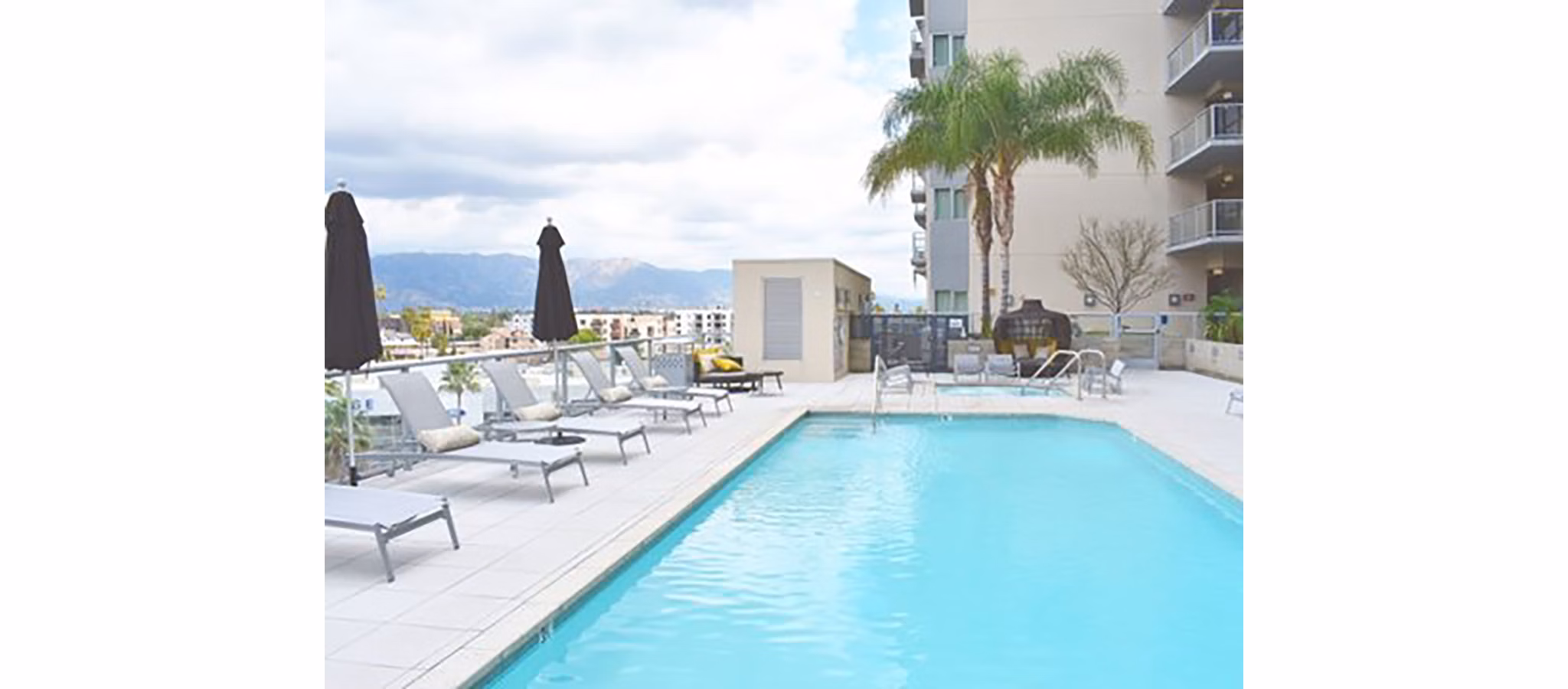 Rooftop pool with city views at NoHo 14 Apartments, a luxury Greystar property