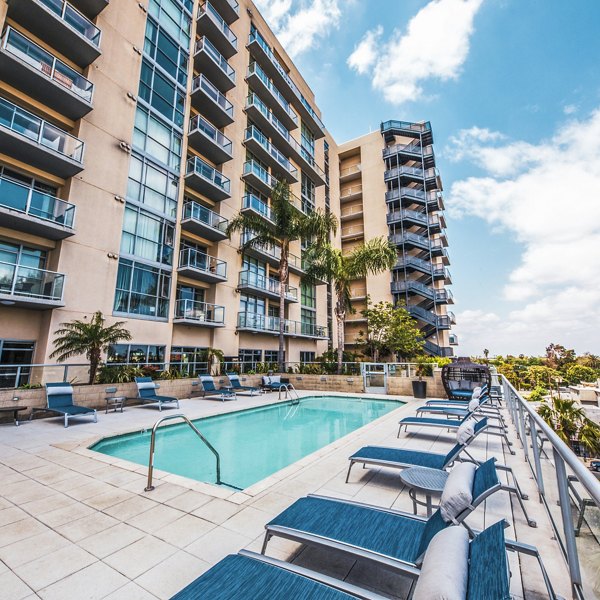 Modern pool with city skyline views at NoHo 14 Apartments