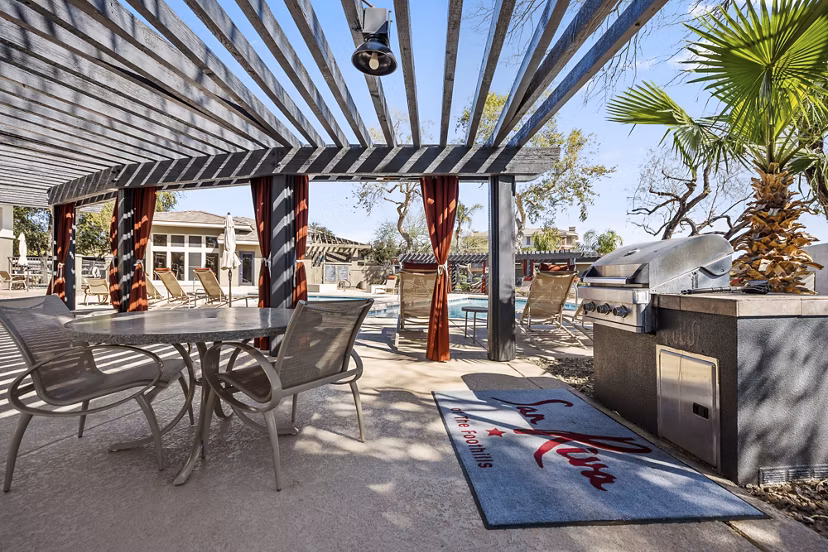 Grill area with seating at San Riva At The Foothills Apartments showing luxury outdoor living space