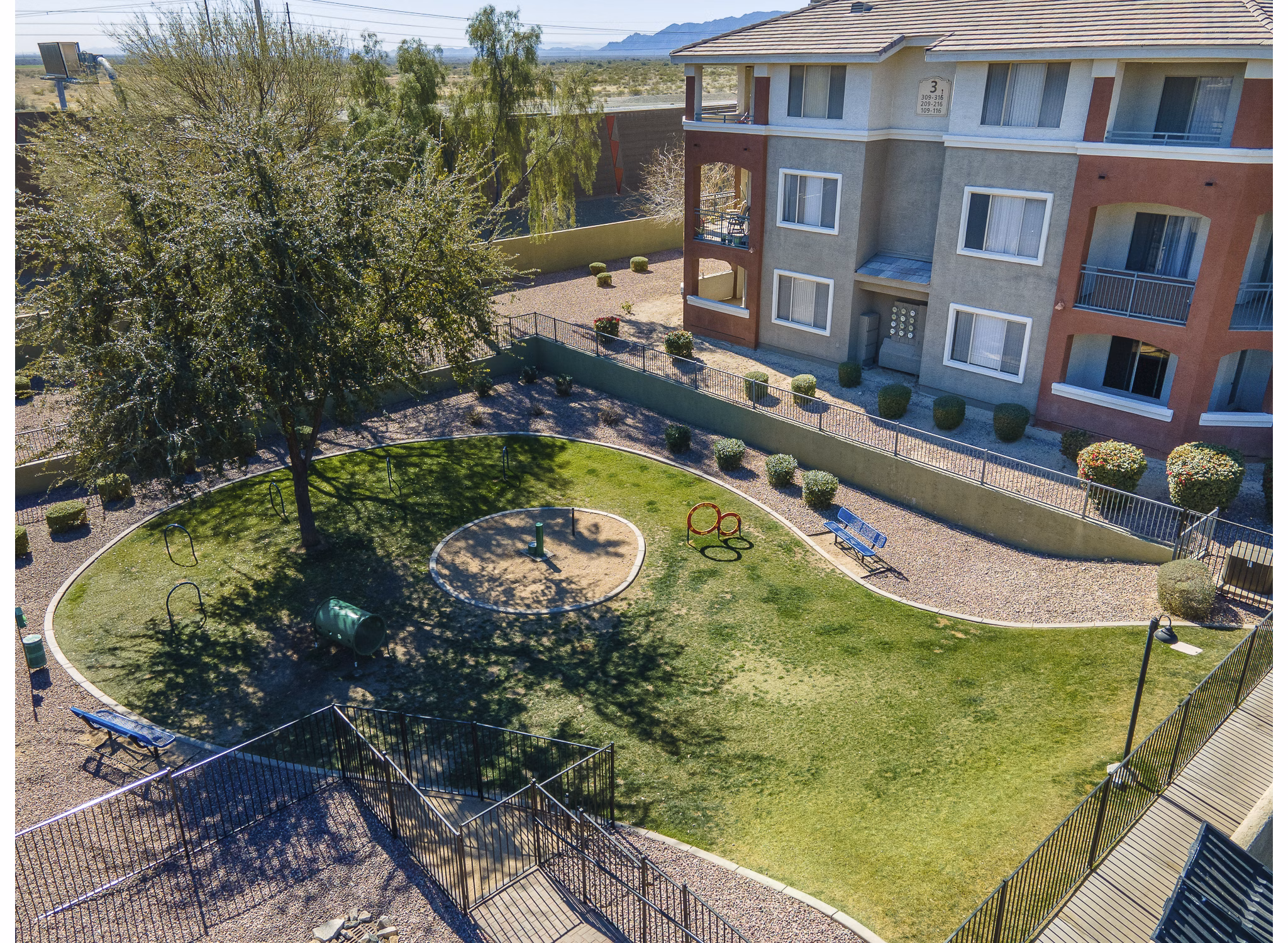 Playground with colorful equipment at San Riva At The Foothills Apartments, perfect for outdoor fun and family activities