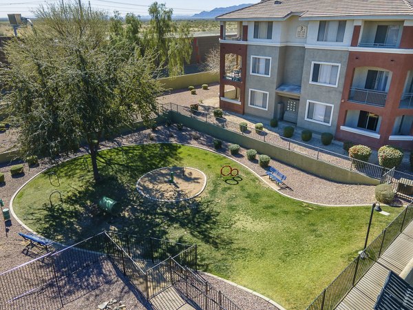 Playground with colorful equipment at San Riva At The Foothills Apartments, perfect for outdoor fun and family activities