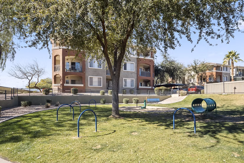 Playground featuring slides and swings at San Riva At The Foothills Apartments, perfect for family-friendly outdoor fun