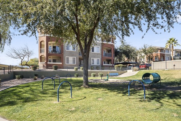 Playground featuring slides and swings at San Riva At The Foothills Apartments, perfect for family-friendly outdoor fun