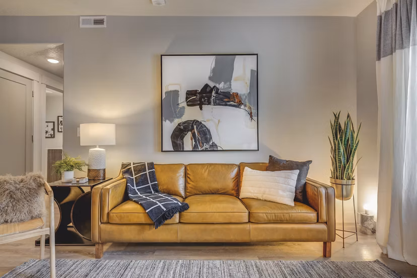Open-concept living room with modern decor and large windows at Bria Apartments