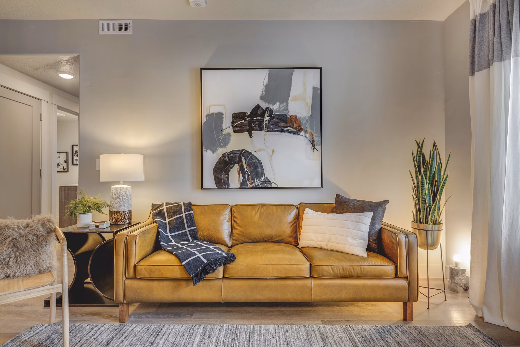 Open-concept living room with modern decor and large windows at Bria Apartments