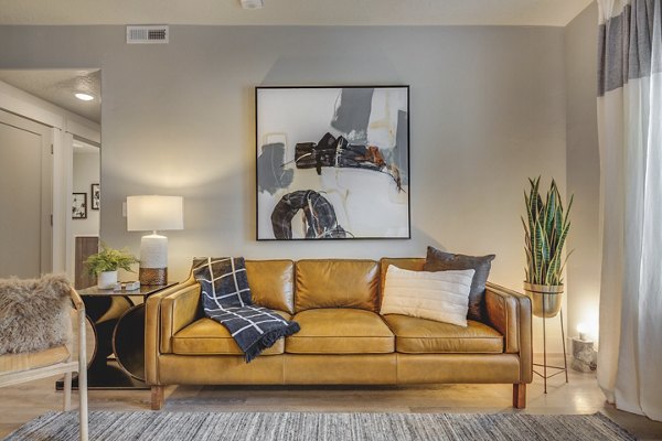 Open-concept living room with modern decor and large windows at Bria Apartments