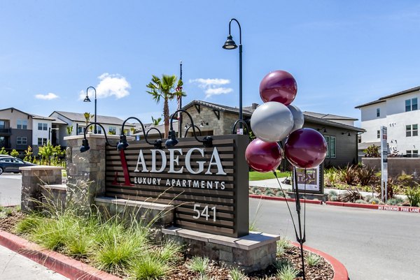 signage at Adega Apartments