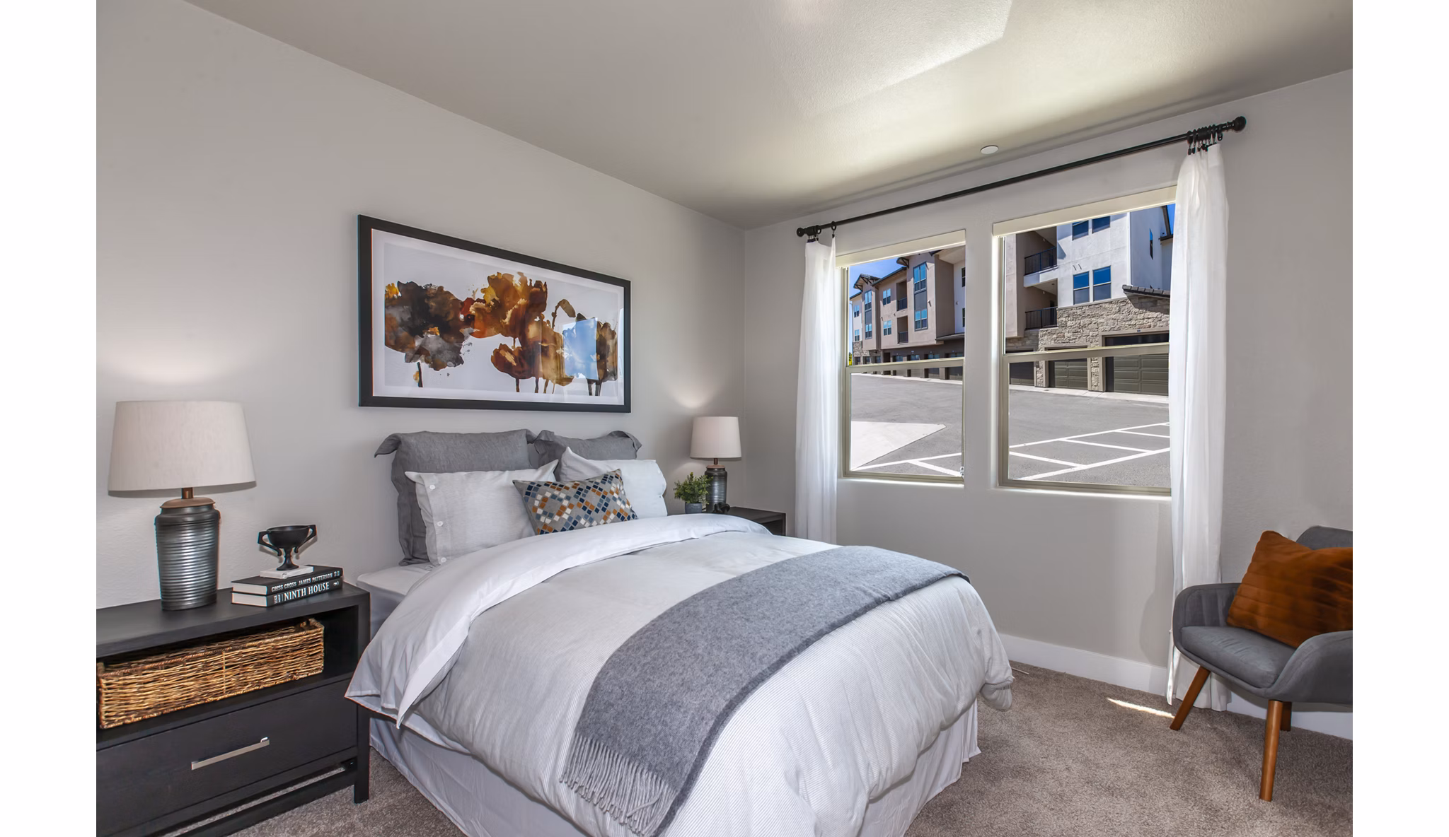Cozy bedroom with modern decor at Adega Apartments, a Greystar luxury community