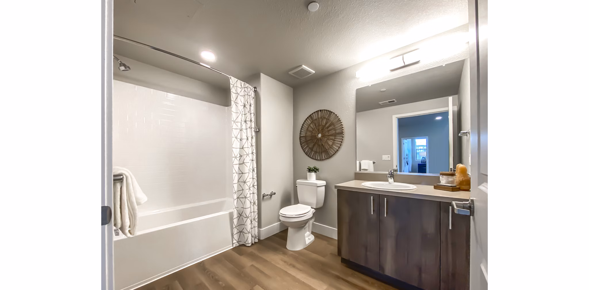 Modern bathroom with marble countertops and sleek fixtures at Adega Apartments