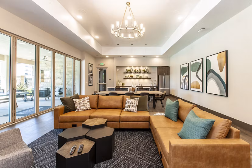 Clubhouse featuring contemporary design and inviting lounge spaces at Adega Apartments