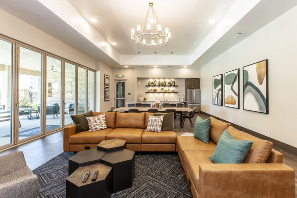 Clubhouse featuring contemporary design and inviting lounge spaces at Adega Apartments