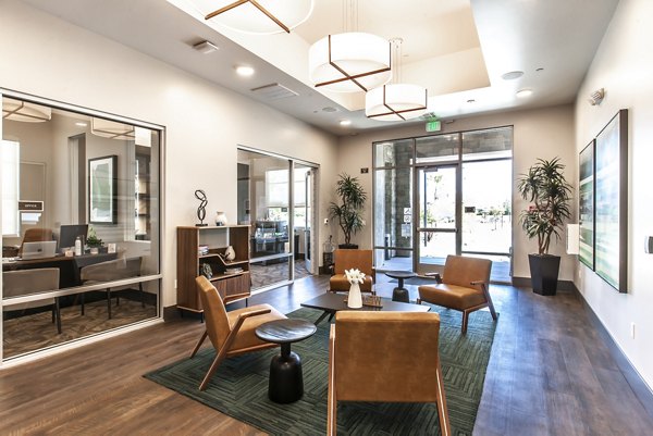 Clubhouse featuring modern design and cozy seating at Adega Apartments