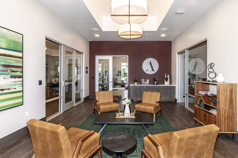 Adega Apartments: Modern clubhouse featuring cozy seating and vibrant decor in a luxury apartment community