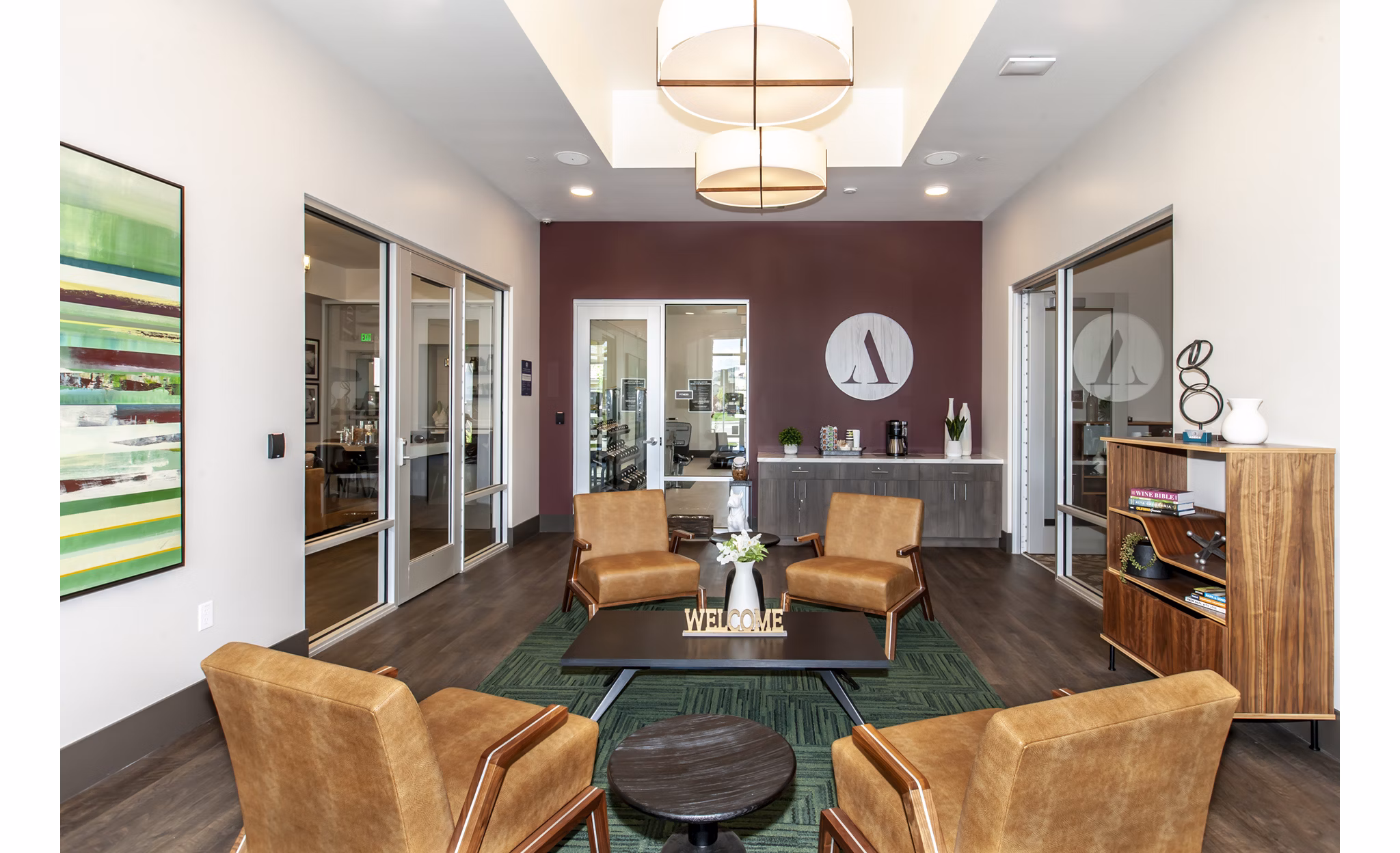 Adega Apartments: Modern clubhouse featuring cozy seating and vibrant decor in a luxury apartment community