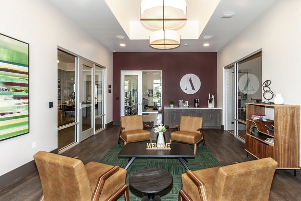 Adega Apartments: Modern clubhouse featuring cozy seating and vibrant decor in a luxury apartment community