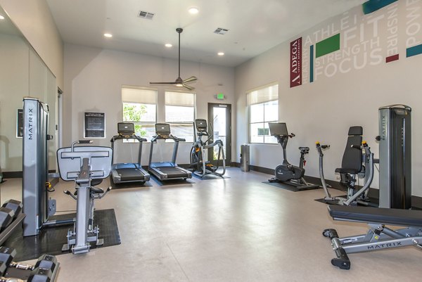 Modern fitness center with state-of-the-art equipment at Adega Apartments, providing a premium workout experience for residents