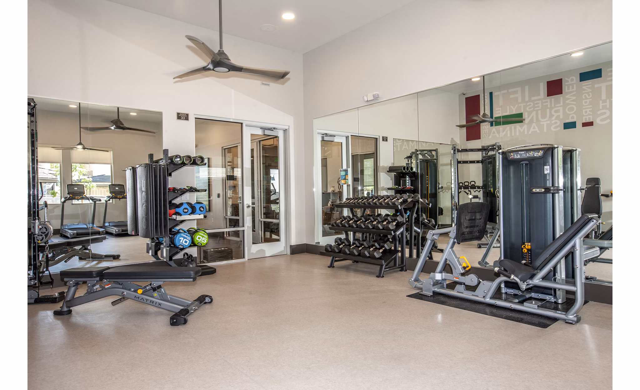 Fitness center with modern equipment at Adega Apartments, offering residents a luxury workout experience