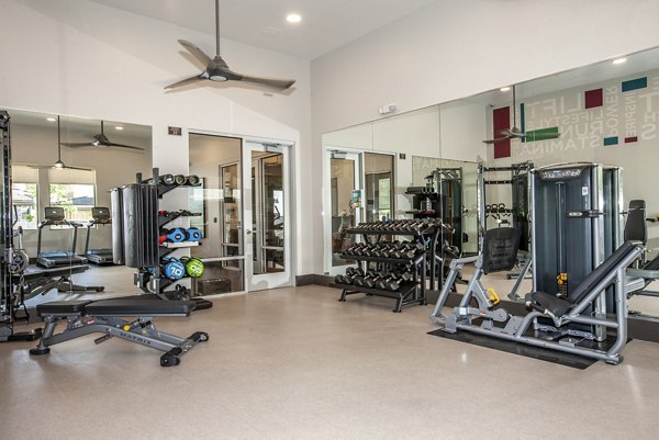 Fitness center with modern equipment at Adega Apartments, offering residents a luxury workout experience
