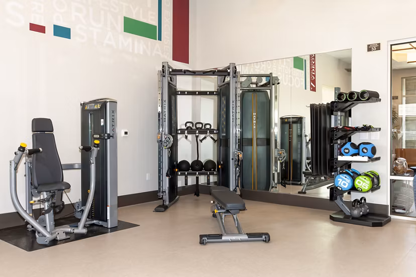 State-of-the-art fitness center with modern equipment at Adega Apartments