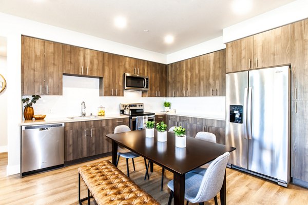 Modern kitchen with stainless steel appliances at Adega Apartments