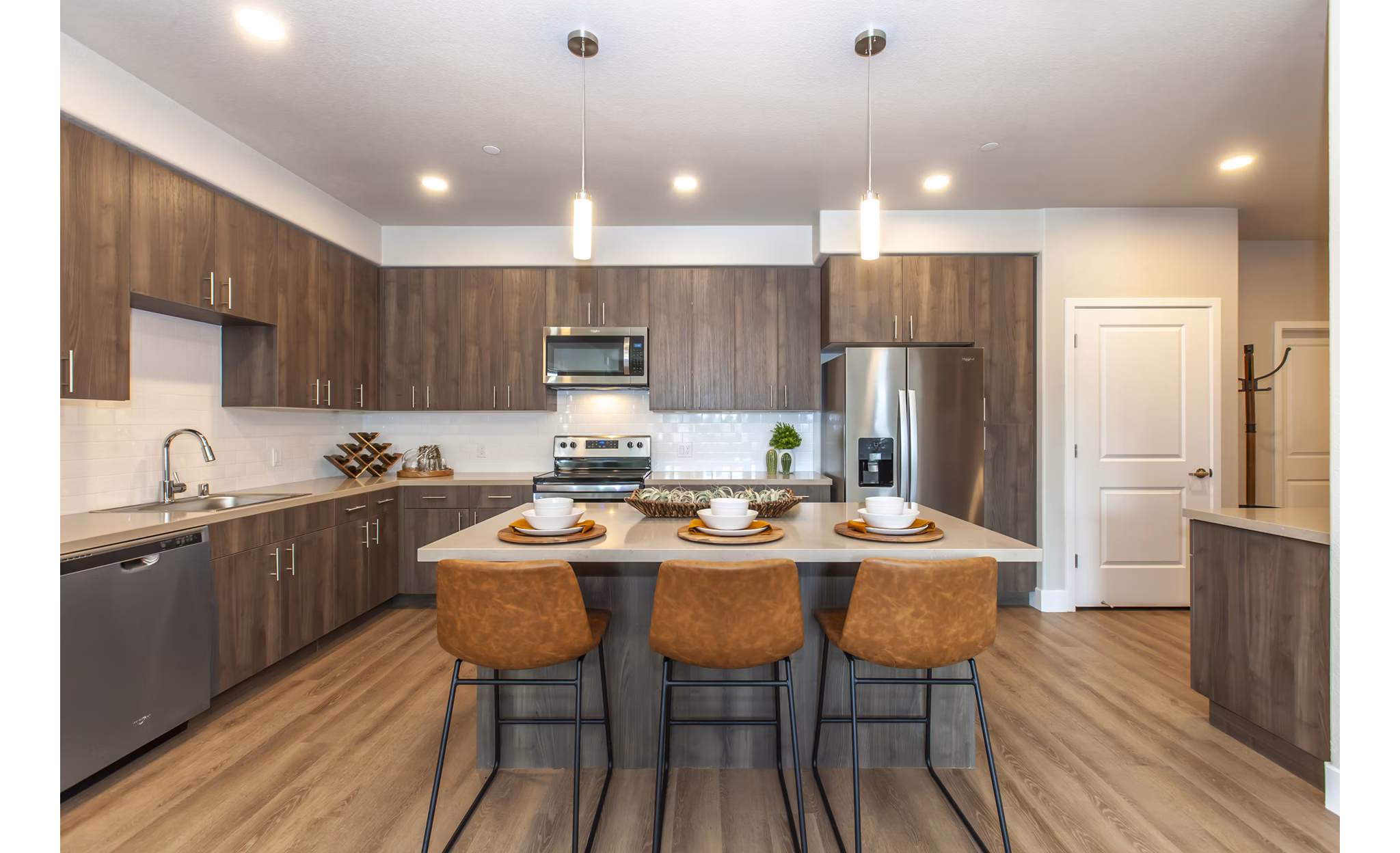Modern kitchen with stainless steel appliances in Adega Apartments