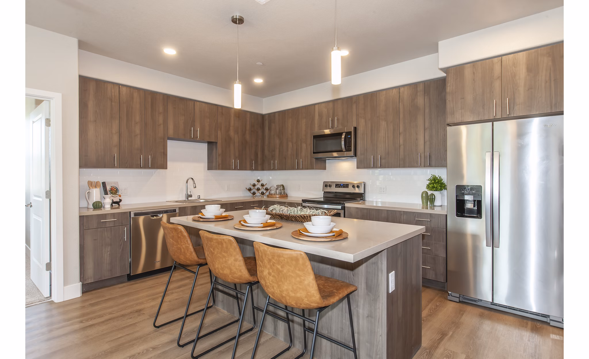 Modern kitchen with stainless steel appliances in Adega Apartments